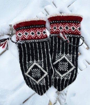 Zoom bild av Mönsterkit stickning tumvantar vantar